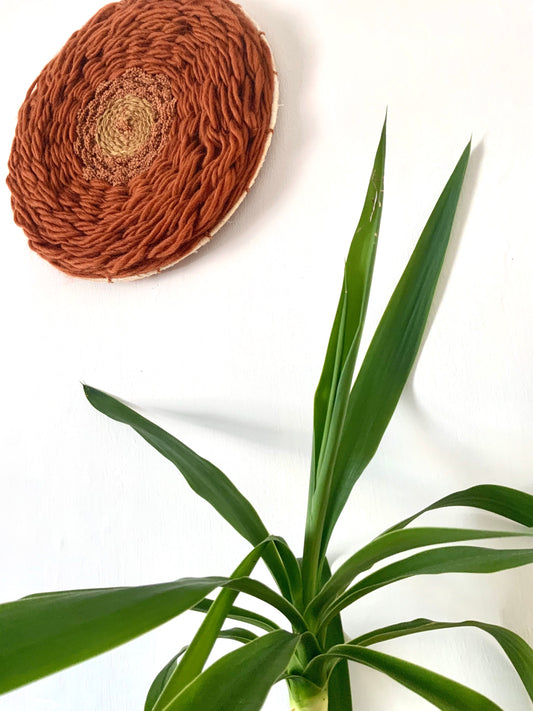 Vintage inspired rust tones circular wool wall hanging