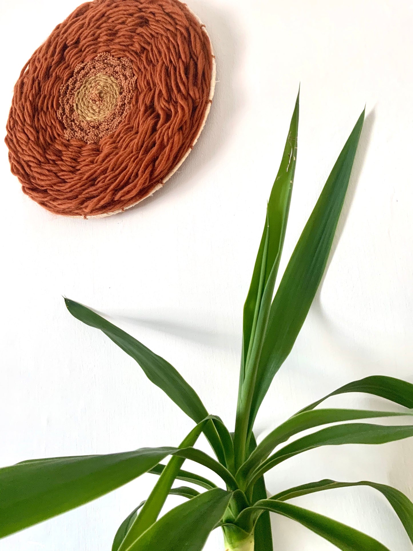 Vintage inspired rust tones circular wool wall hanging